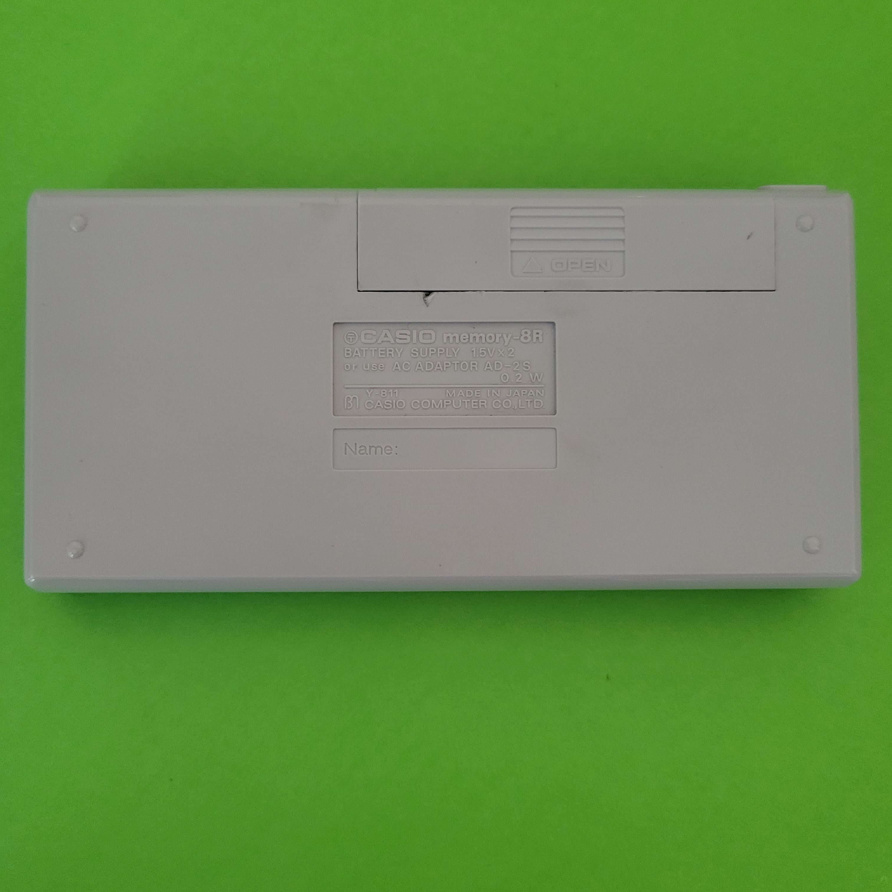 An image of the back of a Casio Memory-8R Four Function + calculator